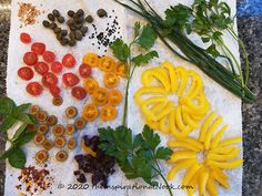 several different types of vegetables are laid out on a piece of paper with herbs and seasonings