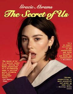 a magazine cover with an image of a woman making a finger gesture to her lips