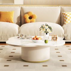 a living room with white couches and yellow pillows on the back of the couch