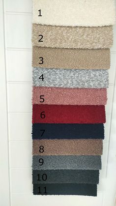 various colors of rugs hanging on the wall with numbers in each row and number