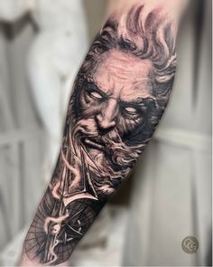 a man's arm with a portrait of an old man holding a bicycle on it