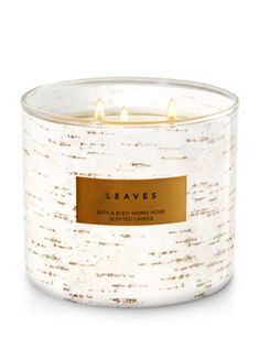 a white candle with gold label on it