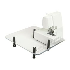 a white sewing machine sitting on top of a table