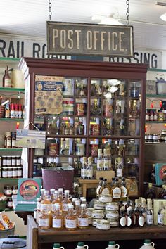 the inside of a store with many bottles and jars on display in front of it