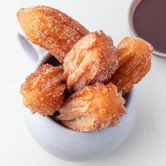 powdered sugar coated doughnuts in a small bowl