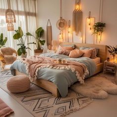 a large bed sitting in a bedroom next to a window filled with potted plants