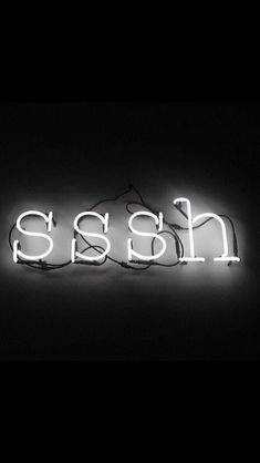 a neon sign that reads hash in white letters on a black background with the word hash underneath it