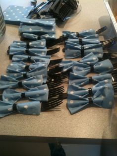 a table topped with lots of blue bow ties