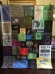 a quilt made to look like it has been written on the side and is being displayed in front of a mirror