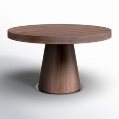 a round wooden table sitting on top of a white floor