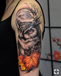 an owl and leaves tattoo on the arm