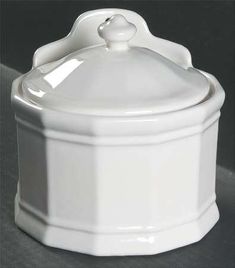 a white ceramic container with a lid