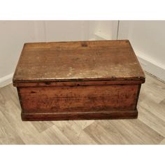 an old wooden box sitting on the floor