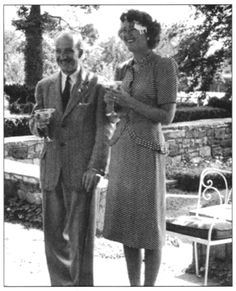 an old black and white photo of two people standing next to each other holding drinks