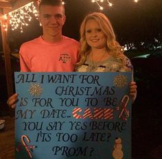 a man and woman are holding up a sign that says, all i want for christmas is for you to be my date