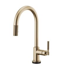 the kitchen faucet is shown in brushed brass, and features an angled spout