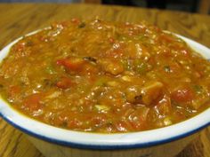 a bowl filled with soup sitting on top of a wooden table