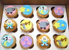 twelve cupcakes in a box decorated with different animals and stars, all on top of each other