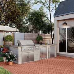 an outdoor kitchen and patio area with brick pavers