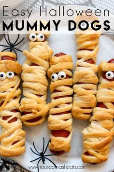 pigs in a blanket with googly eyes on a plate