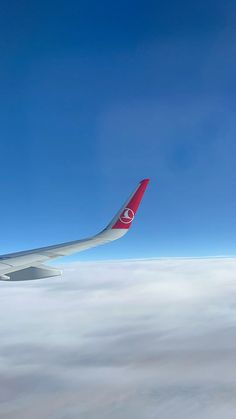 the wing of an airplane flying above the clouds