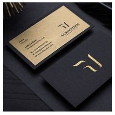 a black and gold business card sitting on top of a table