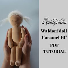 a hand holding a doll with the words waldorf doll caramel 101 on it