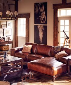 a living room filled with furniture and a fire place in front of a stone fireplace