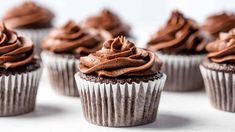 several chocolate cupcakes with frosting on top