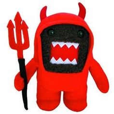 a red stuffed animal with big teeth holding a pitchfork and wearing a devilish costume