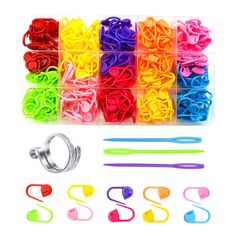 assorted rubber bands and clips in plastic storage box on white background with clippings