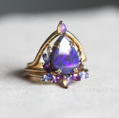 a ring with an opal and amethyst stones