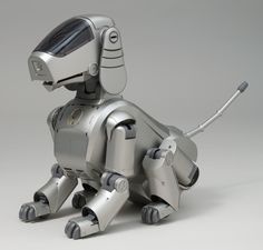 a robot dog sitting on the ground with its head turned to look like it is talking