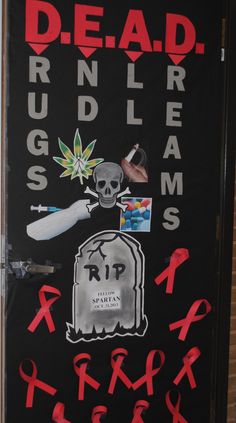 a door decorated with various stickers and graffiti on it's side, including a tombstone