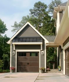 two garages in front of each other on the side of a house