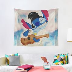 a living room with a couch, coffee table and wall hanging featuring a cartoon character playing the guitar