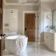 a large white bath tub sitting inside of a bathroom