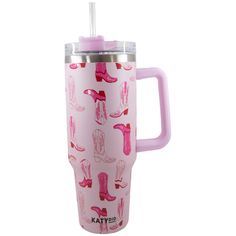 a pink travel mug with cowboy boots on it and a straw sticking out of the cup