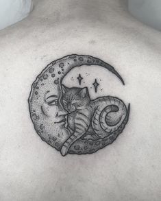 a man's back with a cat sitting on the moon and stars above it