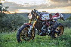 a motorcycle parked on top of a lush green field