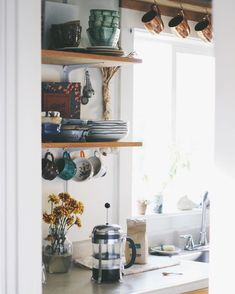 the kitchen counter is clean and ready to be used for coffee or tea, as well as other items