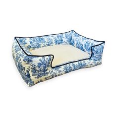 a blue and white dog bed with an animal design on the bottom, sitting in front of a white background