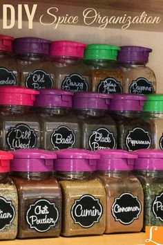 spice jars are stacked on the shelf in front of each other and labeled with labels