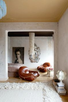 a living room with white carpet and leather furniture