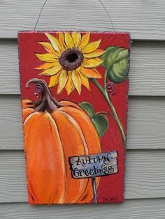 a painting of a pumpkin and sunflower on a red background with the words autumn greetings written below it