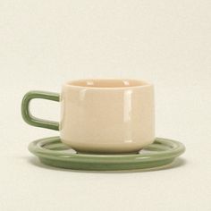 a cup and saucer sitting on top of each other