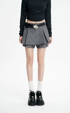 Revamp your wardrobe with the timeless chic of our Pleated Mini Skirt featuring an eye-catching oversized belt detail. This mini skirt channels a blend of sophistication and playful charm with its high-waisted A-line silhouette and crisp pleating. Crafted from a mix of polyester and viscose fibers, it provides both comfort and a flattering drape. The solid color and retro vibe make it a versatile piece for a multitude of settings, from casual outings to more formal affairs. Style this skirt with Chic Mini Length Bottoms With Belt Loops, Chic Mini Bottoms With Belt Loops, Chic Workwear Shorts With Belt Detail, Elegant Pleated Skirt With Belt, Belted Mini Length Bottoms For Workwear, Workwear Short Pleated Skirt With Belt Loops, Workwear Pleated Skirt With Belt Loops, Short Length, Chic Belted Skirt For Summer, Chic Shorts With Belt Detail For Spring