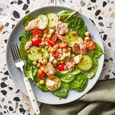 a salad with cucumbers, tomatoes and chickpeas