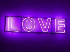 a purple neon sign that says love on it