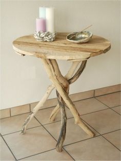 a wooden table with two candles on top of it and a plate next to it